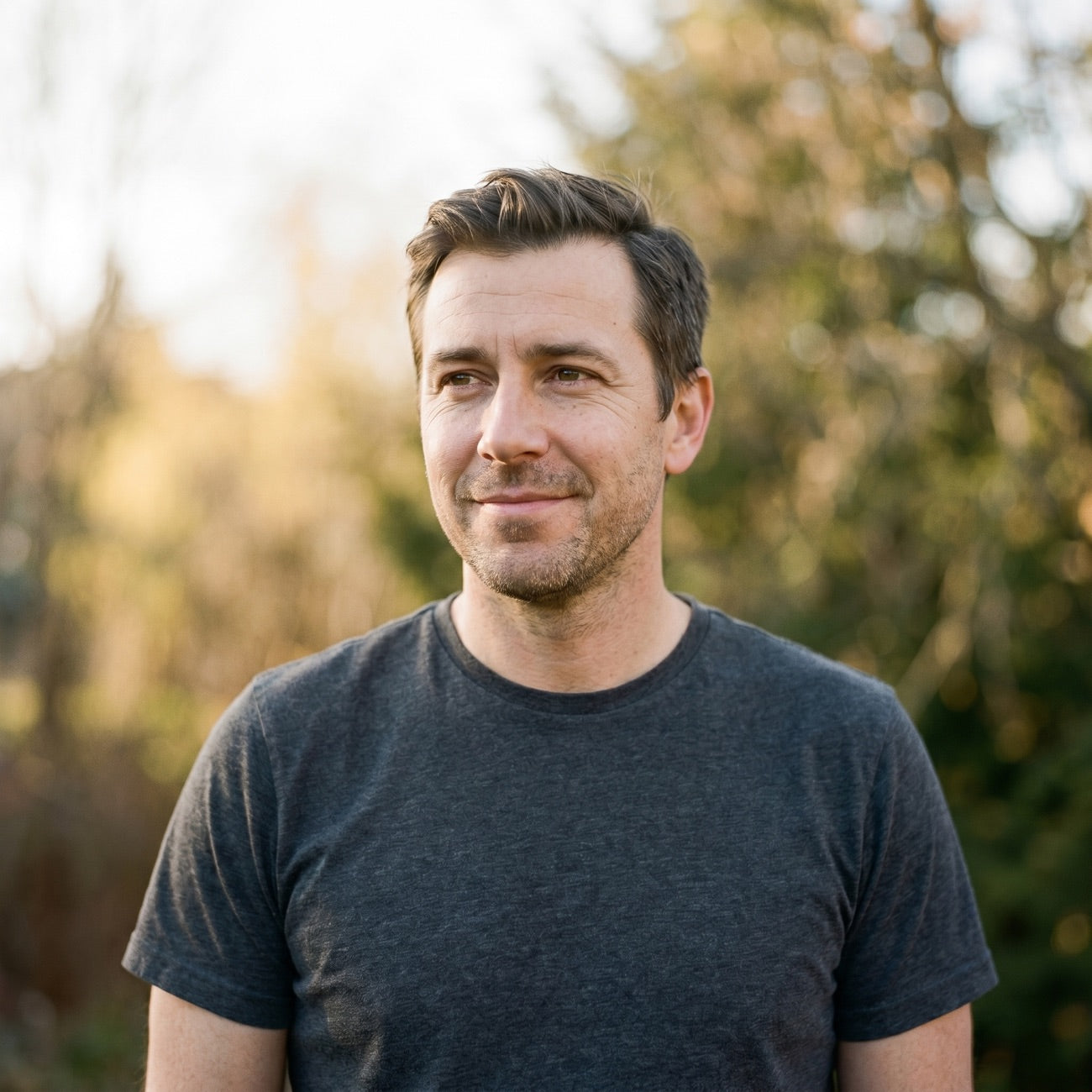 A calm, confident man outdoors in natural light